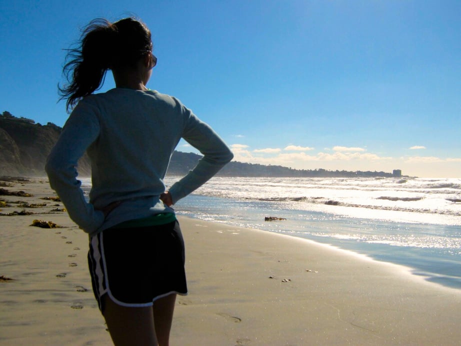 Anokhi Kapasi at Torrey Pines Beach in San Diego looking into the horizon with an optimistic mindset for reaching her ambitions