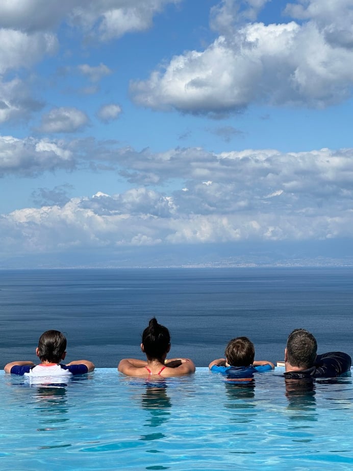 Our family travels and adventures together to build a strong connection, seen here overlooking the sea in Taormina, Sicily