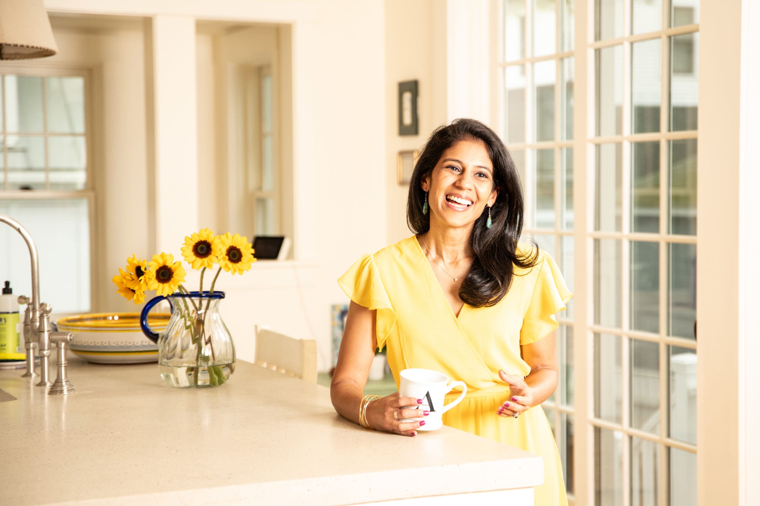 Anokhi in a yellow dress feeling free and joyful